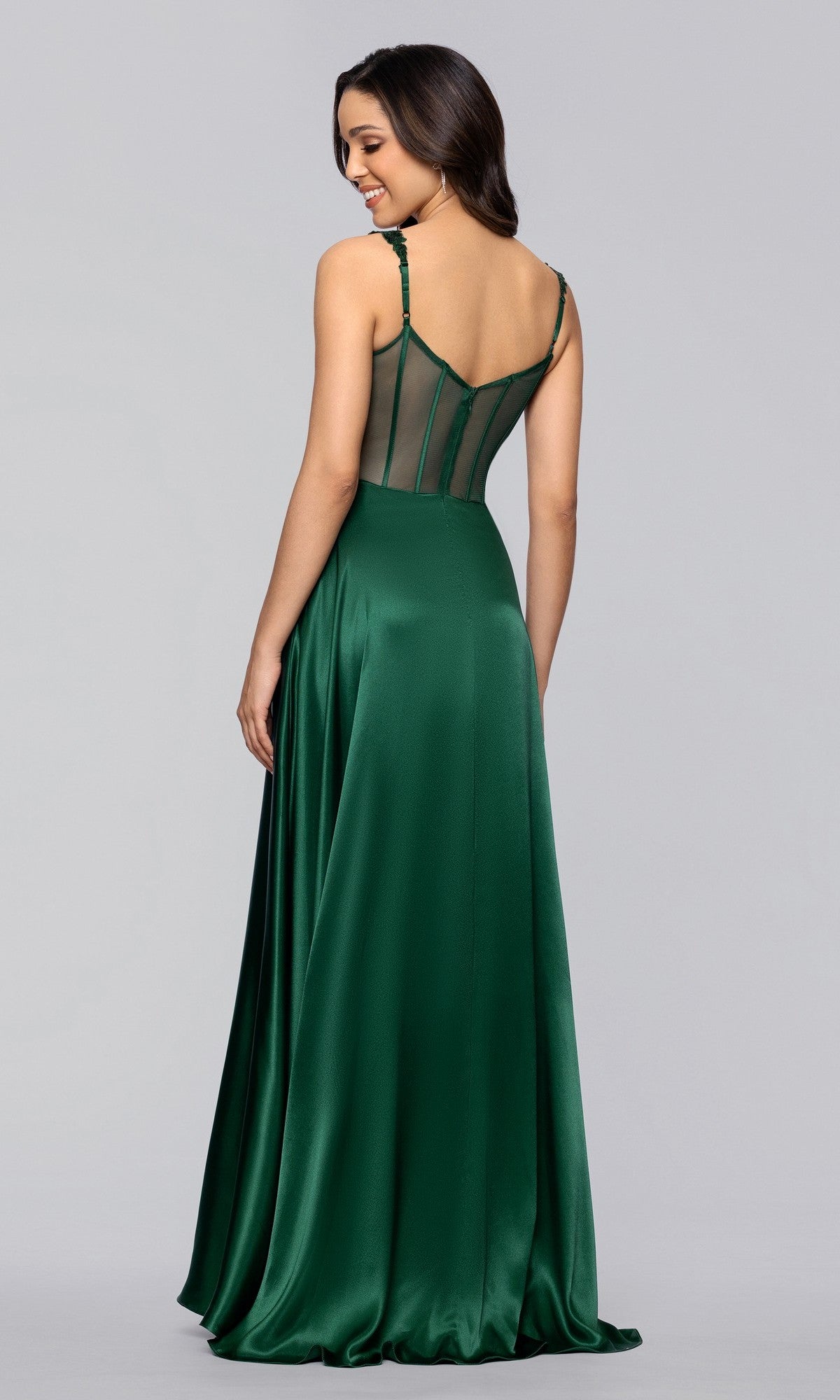Model wears the Blondie Nites 6088BN long prom dress featuring an A-line satin skirt, sequin-embellished bodice, and sheer corset-style back, posing with her back to the camera against a plain background.